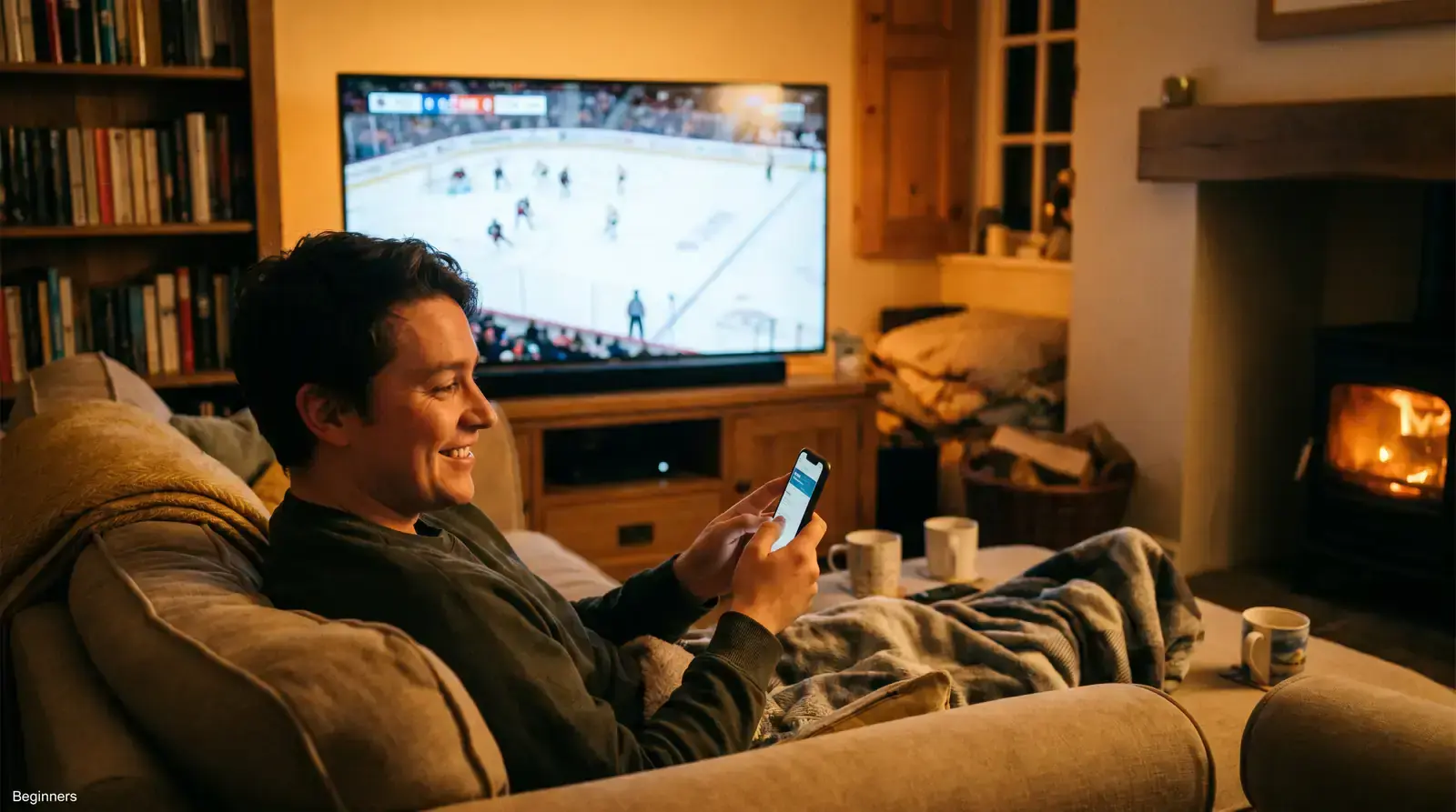 A first-time bettor watching an ice hockey game on a phone with a rink in the background