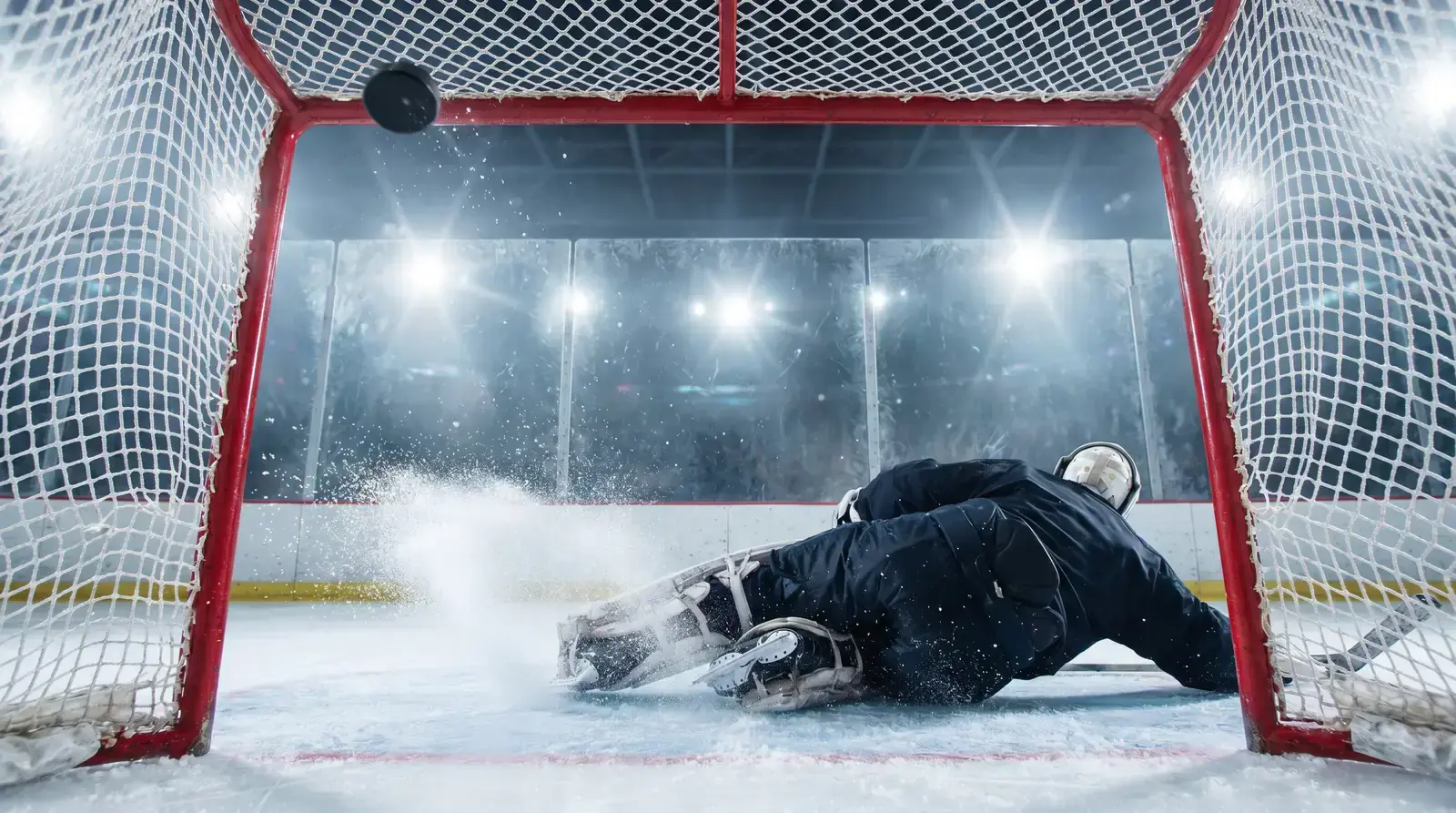 Ice hockey puck crossing the goal line during a two-goal margin win